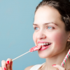 Girl in braces eating hard candy