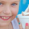 Young girl with braces eating ice cream
